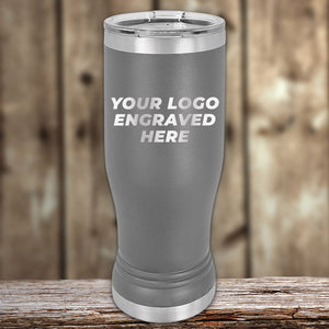 Stainless steel Custom Pilsner Tumblers 14 oz with your Logo or Design Engraved displayed on a wooden surface by Kodiak Coolers.
