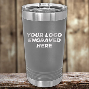 Custom Pint Tumblers 16 oz with your Logo or Design Engraved - Low 6 Piece Order Minimal Sample Volume by Kodiak Coolers, displayed on a wooden surface.