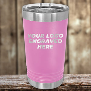 A pink Custom Pint Tumbler 16 oz with your Logo or Design Engraved by Kodiak Coolers placed on a wooden surface.