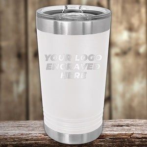 Custom Pint Tumblers 16 oz with Slider Lid by Kodiak Coolers with double-walled insulation and customizable engraving space displayed on a wooden surface.