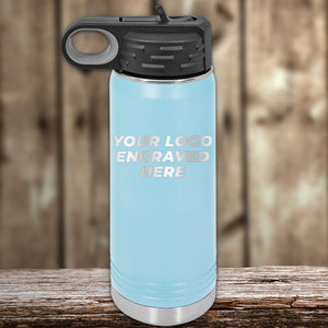 An Insulated Stainless Steel Custom Water Bottle 20 oz with your Logo or Design Engraved - Special Bulk Wholesale Volume Pricing, by Kodiak Coolers, on the blue body, topped with a black lid, resting on a wooden table.