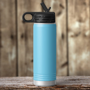 A Kodiak Coolers Custom Water Bottle 20 oz with your Logo or Design Engraved - Special Black Friday Sale Volume Pricing - LIMITED TIME, featuring a blue body and a black lid, is resting on a wooden table.