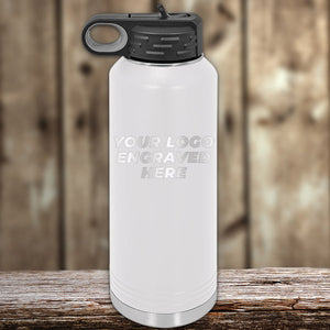 White Custom Water Bottles 40 oz with your Logo or Design Engraved - Low 6 Piece Order Minimal Sample Volume displayed on a wooden surface against a blurred wooden background by Kodiak Coolers.