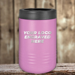 A pink insulated tumbler with an engraved Kodiak Coolers logo area on a wooden surface.