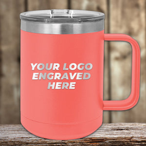 A coral-colored Kodiak Coolers mug with a metal lid rests on wood. "YOUR LOGO ENGRAVED HERE" promotes Engraved Custom Logo Drinkware—single side engraving included, bulk pricing available—ideal for custom brand or event mugs.