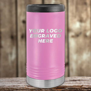 A pink Custom Slim Seltzer Can Holder with your Logo or Design Engraved by Kodiak Coolers, displayed on a wooden surface.