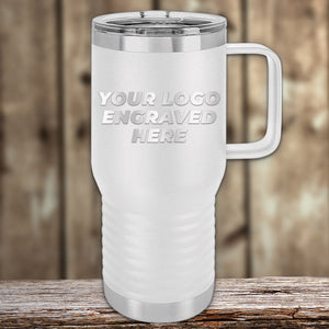A white Kodiak Coolers stainless steel travel mug with a handle sits on a wooden surface, displaying "YOUR LOGO ENGRAVED HERE"—a perfect Engraved Custom Logo Drinkware for personalized mugs or business gifts. Single side engraving & bulk pricing included.