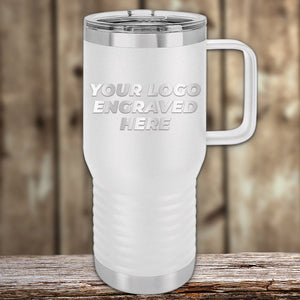 Kodiak Coolers Silver insulated travel tumbler with a handle featuring customizable engraving space for an engraved logo, displayed on a wooden surface with a blurred background.