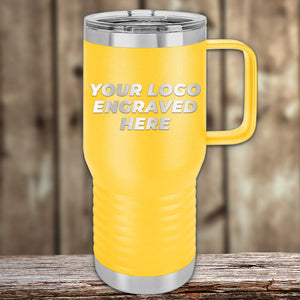 Yellow insulated Kodiak Coolers custom travel tumblers with an engraved logo on a wooden surface against a blurred background.