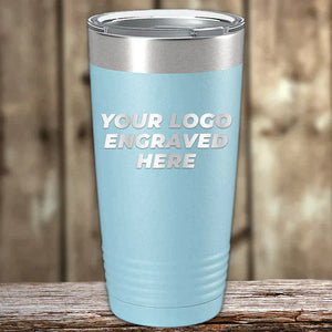 A set of 6 Kodiak Coolers 20 oz tumblers in light blue with silver lids, custom laser engraved with "YOUR LOGO ENGRAVED HERE," perfect for low volume promotional orders. No setup fees and free shipping included. Set against a wooden background.