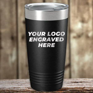 A set of 6 Kodiak Coolers 20 oz black tumblers with silver lids sits on a wooden surface, each custom laser engraved with "YOUR LOGO ENGRAVED HERE"—ideal for low volume bulk orders, custom gifts, or promotional use. No setup fees, free shipping!.
