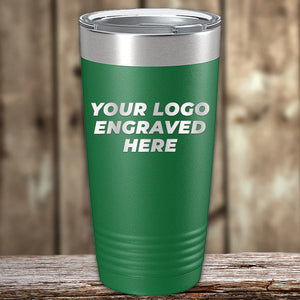 Green insulated Kodiak Coolers custom tumbler with placeholder text for engraved logo on wooden surface.