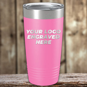 A pink Kodiak Coolers stainless steel tumbler with metal lid sits on wood, featuring "YOUR LOGO ENGRAVED HERE." This Engraved Custom Logo Drinkware includes single side engraving and bulk tiered pricing, ideal for branding or personalization.