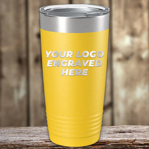 Yellow Kodiak Coolers insulated tumbler with an engraved logo space on a wooden surface.