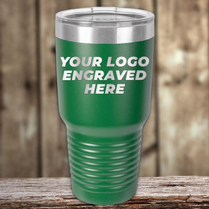 A green insulated tumbler from Kodiak Coolers with "your logo engraved here" text, ideal as a corporate promotional gift, placed on a wooden surface.