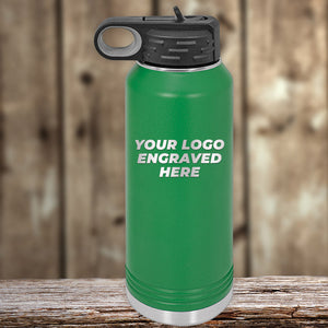 Kodiak Coolers New Years Sale - Custom Logo Drinkware in green stainless steel with black lid, laser engraved with your logo or design on front—1 side included—no setup fee; shown on a wooden surface with blurred wood background.
