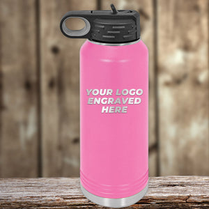 A pink Kodiak Coolers bottle with a black lid sits on wood, featuring "Your Logo Engraved Here." This Engraved Custom Logo Drinkware includes single-side engraving and bulk tiered pricing—ideal for matching or promoting your custom mugs.