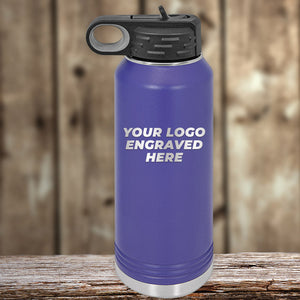 A blue Kodiak Coolers drinkware bottle with a black lid sits on wood, featuring "YOUR LOGO ENGRAVED HERE"—a stylish addition to your custom mug collection. Single side engraving included; enjoy bulk tiered pricing.