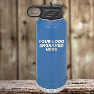 Blue Kodiak Coolers insulated water bottle with engraved logo space on a wooden surface.