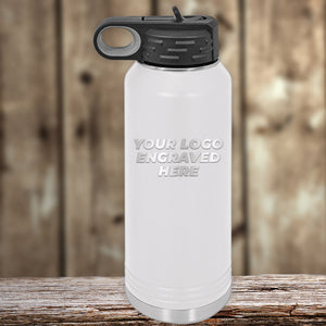 A white Custom Water Bottles 32 oz with your Logo or Design Engraved - Special Bulk Wholesale Volume Pricing water bottle with a black lid sitting on a wooden table, featuring a laser-engraved Kodiak Coolers logo.